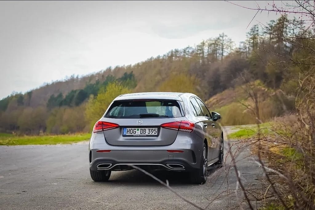 Mercedes-Benz A-Klasse W177 Heckansicht auf kurviger Landstraße in natürlicher Umgebung